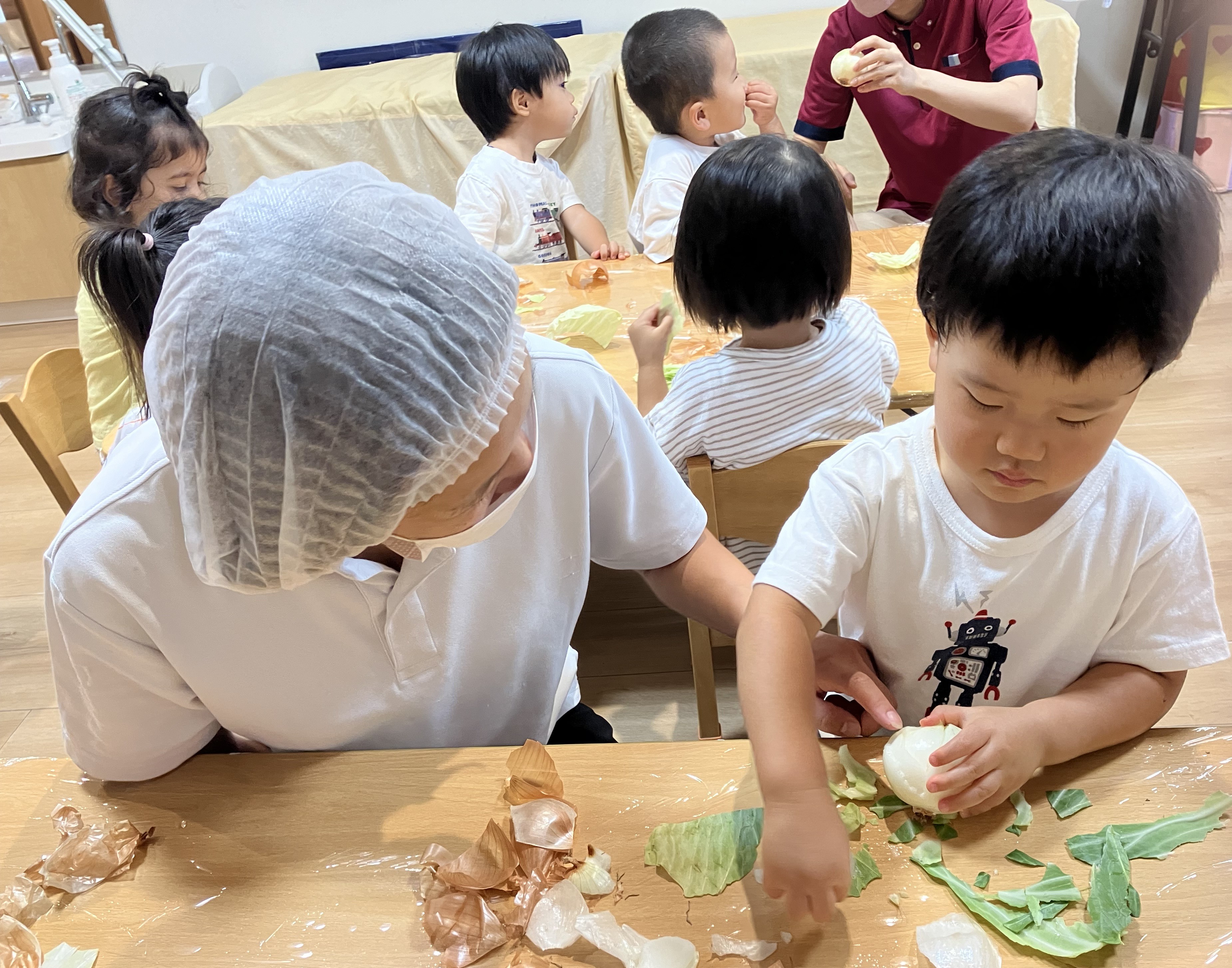 2歳児しずく組　食育「玉ねぎ皮むき/キャベツちぎり」